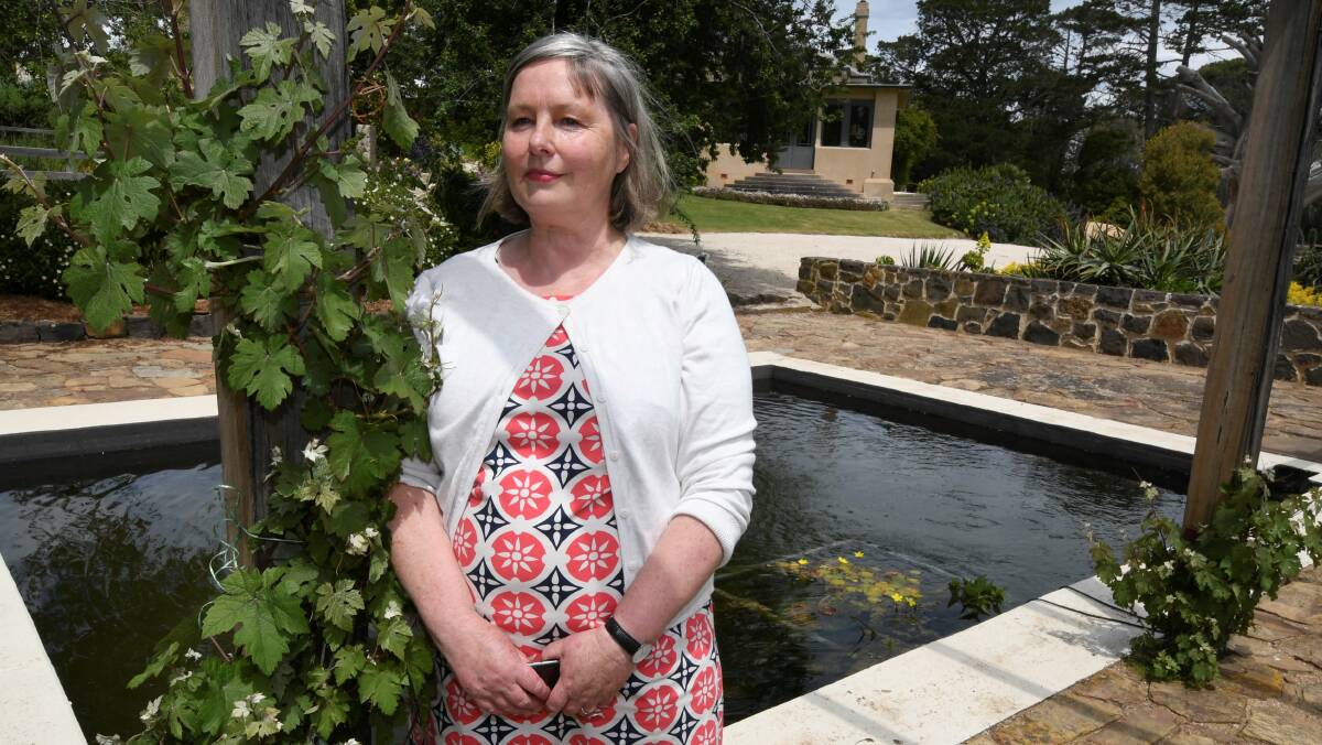 NEW: Eurambeen's Sarah Beaumont stands by the restored water feature, a promise for open garden.