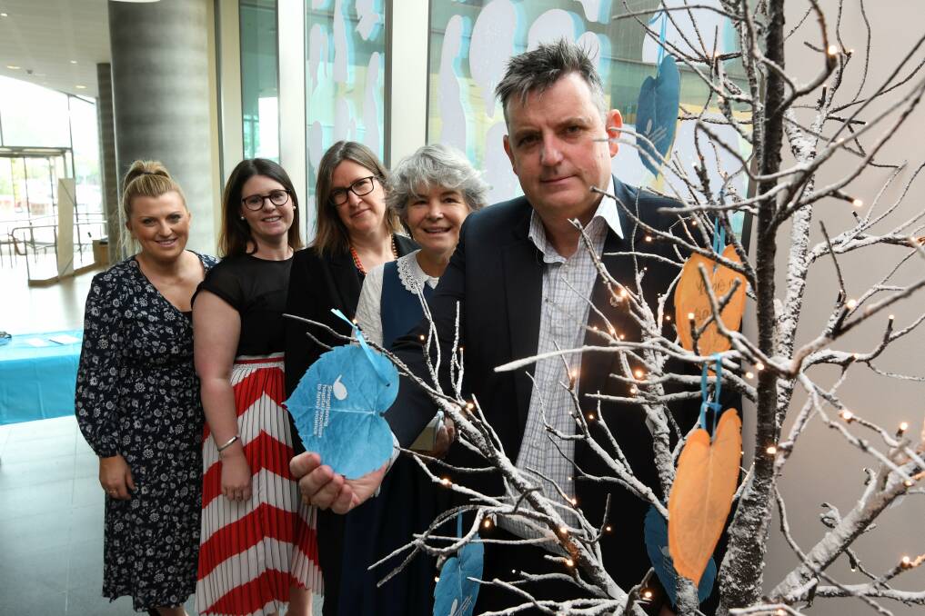 AWARENESS: Ballarat Health Services and WRISC are offering support for women experiencing family violence via the Tree of Hope, which is also a reminder for the importance in culture improvement for gender equality. Dee Honeychurch, Simone Meade and Kristen Sheridan with WRISC executive officer Libby Jewson and BHS chief Dale Fraser on Tuesday. Picture: Lachlan Bence