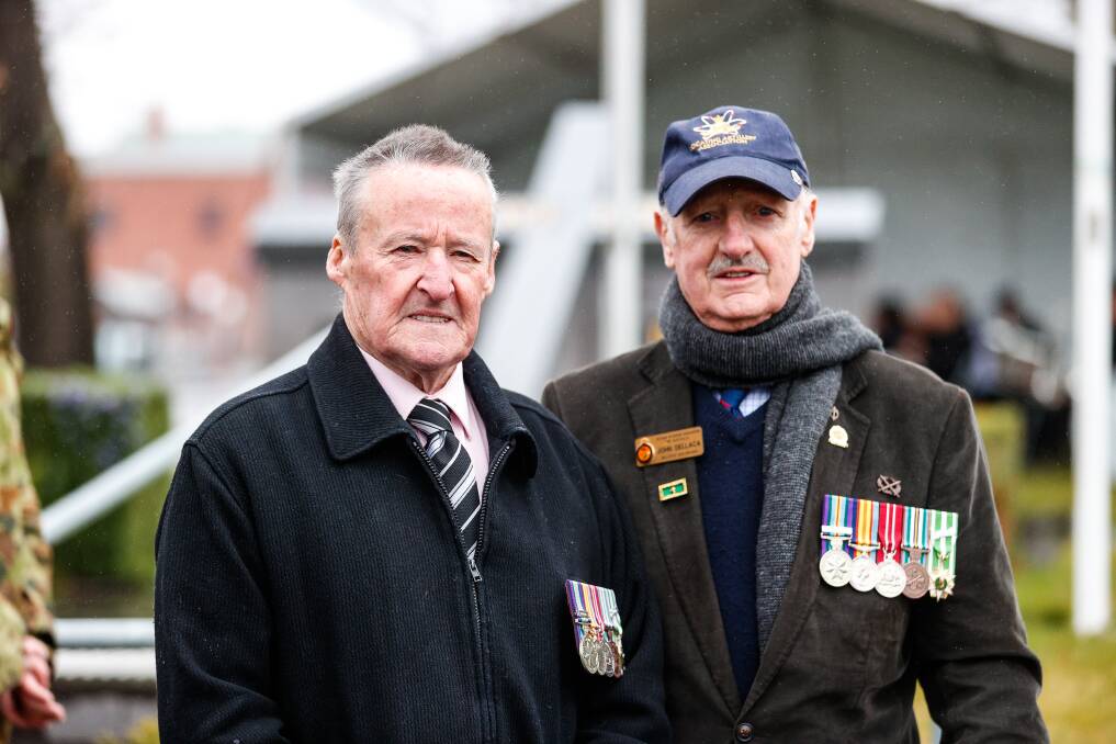 TOGETHER: Greg Jones and John Dellaca at the Vietnam Veterans Memorial on Sunday. Picture: Luke Hemer.