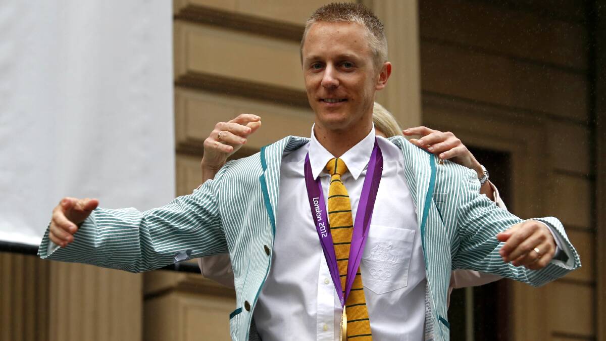 RECOGNITION: Jared Tallent receives his 2012 London 50km race walking gold medal - four years after the Olympic Games, outside Melbourne Town Hall. Picture: The Age