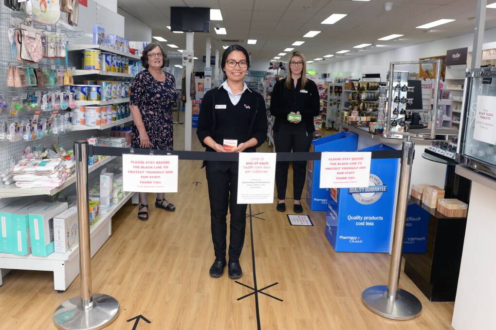 SERVICE: UFS chief executive officer Lynne McLennan, pharmacist Lyxen Mangune and retail coordinator Stacey Matthews with a borrowed barrier at the Doveton Street South pharmacy. Picture: Kate Healy