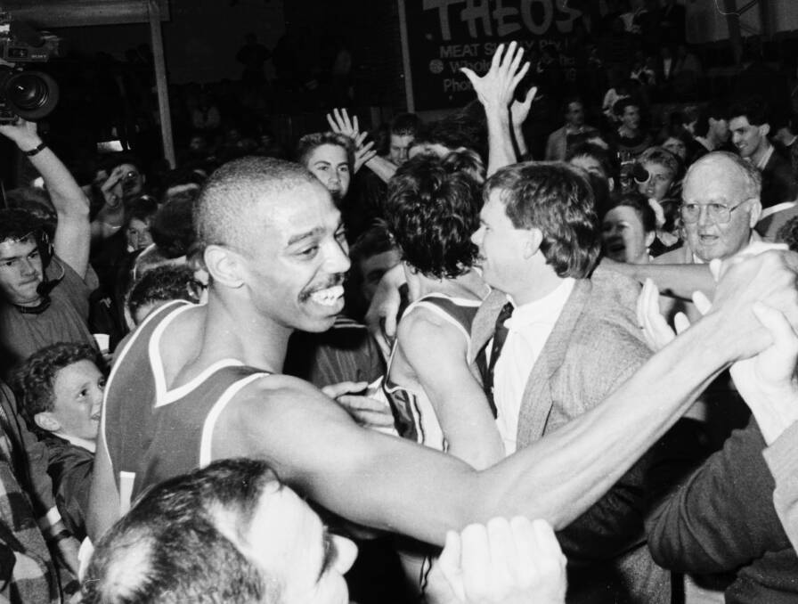 PIVOTAL: Jim Murphy reporting on the Miners' historic win amid celebrations with star Eric Cooks and coach Al Westover in 1989. Picture: Lachlan Bence