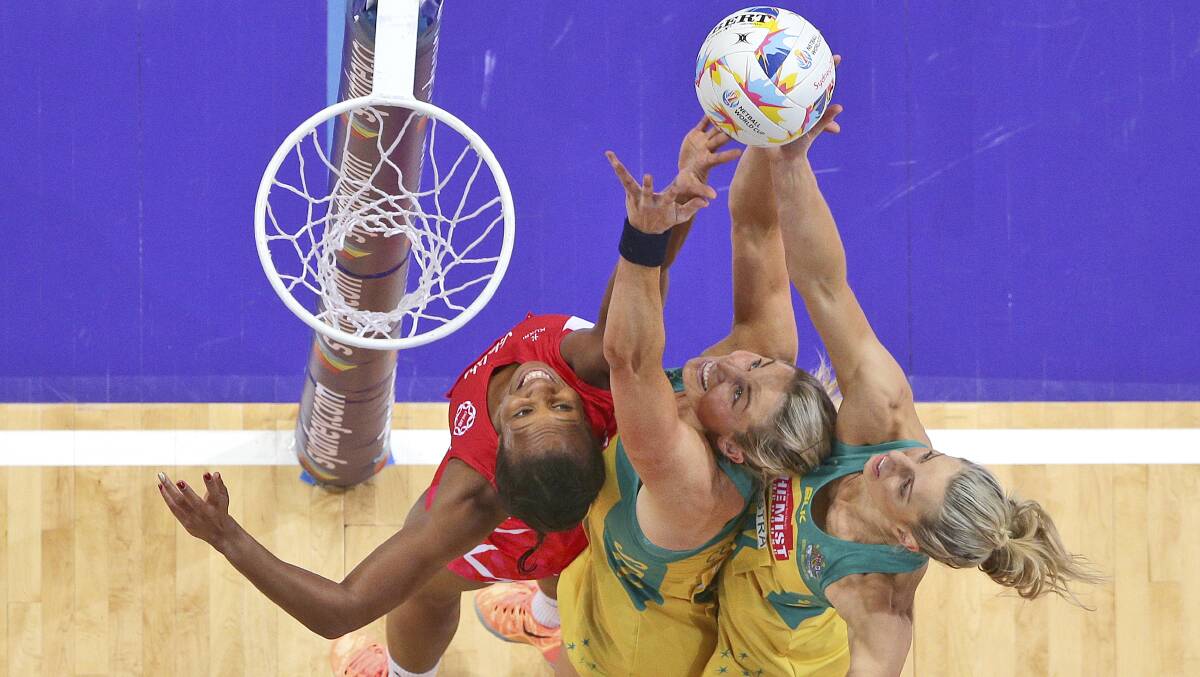 ACTION: England's Pamela Cookey, left, battles Australia's Julie Corletto, center, and Laura Geitz during their Netball World Cup in Sydney in 2015. Picture: AP