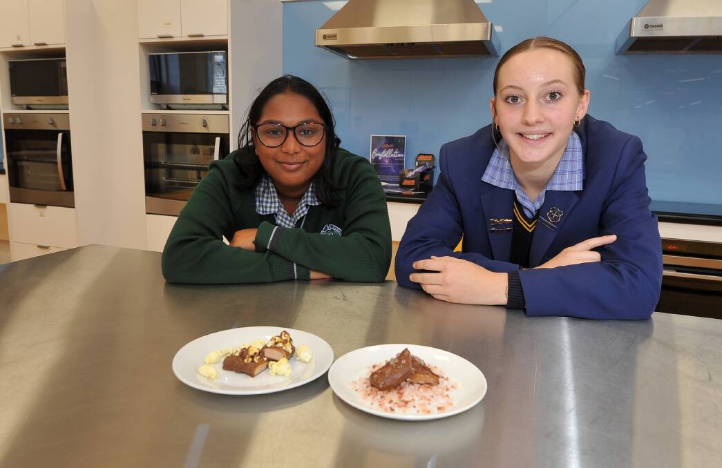 DELICIOUS TWIST: Ballarat High School's Sindhura Sewgolam and Damascus College's Paris Govan present their group's sweet treats at Ballarat Tech School on Tuesday. Picture: Lachlan Bence