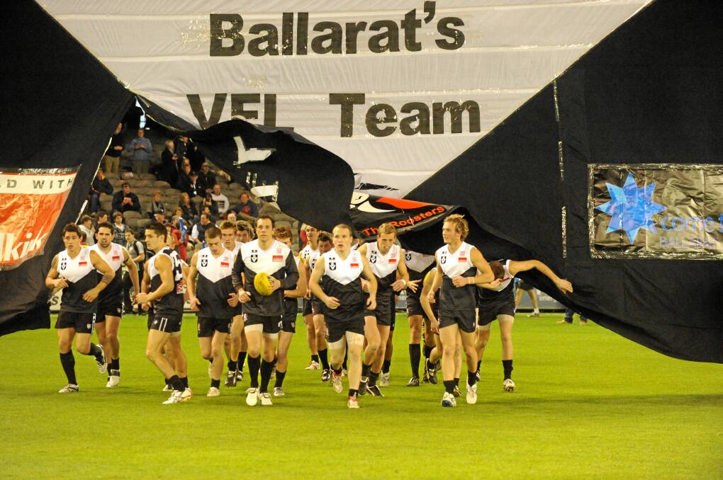 REPRESENT: The Roosters, pictured running out for the VFL grand final as defending premier a year later, put Ballarat football on the sporting map.