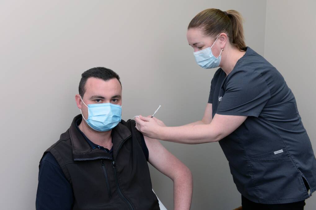 TARGET: Integra project manager Matt Green, aged 27, gets his AstraZeneca jab from UFS nurse Trish Libbis on Friday morning. Picture: Kate Healy