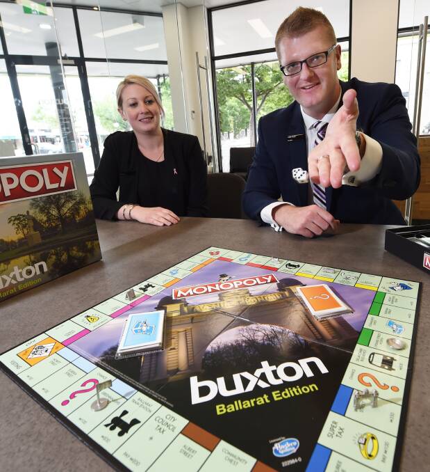 STREET VIEW: Buxton sales administrator Jodie Burley and director Mark Nunn roll the dice on Ballarat Monopoly. Picture: Jeremy Bannister