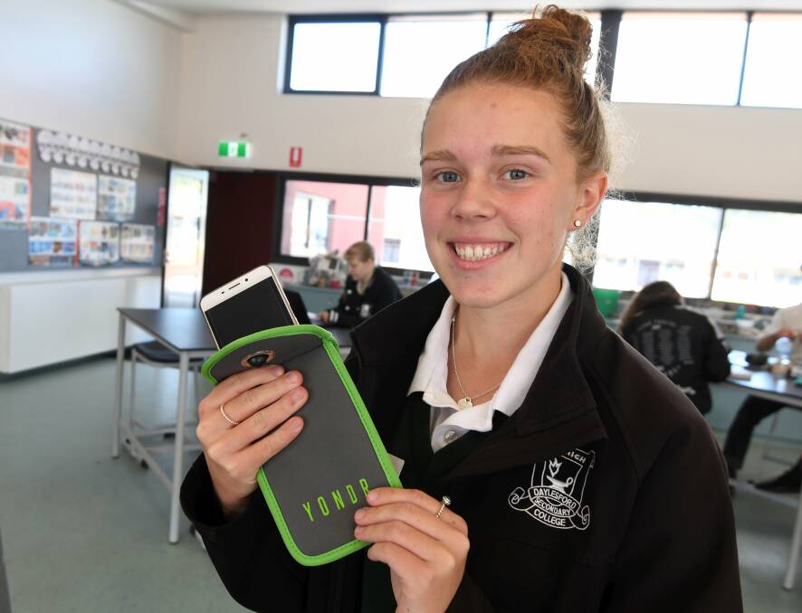 TEST: Daylesford Secondary student Lucinda Lowe nervously packs her phone in a Yondr pouch to be locked up for the school day in the awareness exercise. Picture: Lachlan Bence