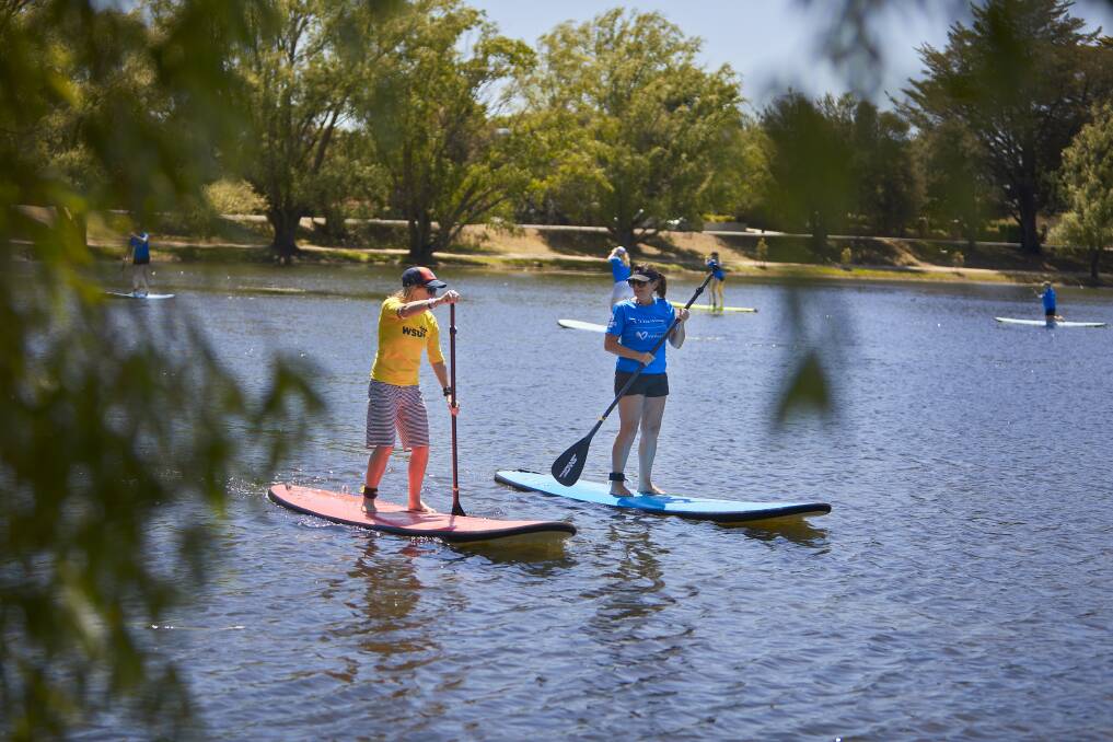 MOVING: Trish Squire picks up technique tips from her instructor in a stand up paddleboarding lesson on Lake Wendouree on Saturday morning. Picture: Luka Kauzlaric