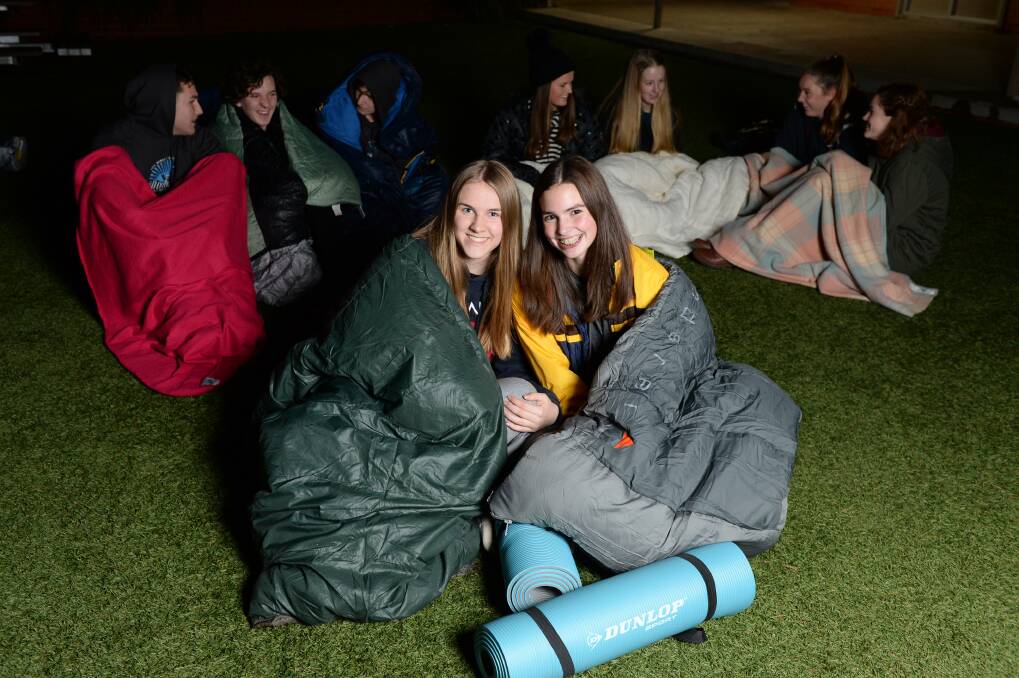SUPPORT: Grammar year 10s Grace Crook and Sophie John prepare for a cold night. All bedding will be donated to the homeless. Picture: Kate Healy
