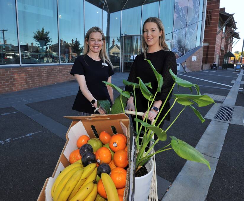 BRIGHT NOTE: Grampians Health interim chief people officer Claire Woods gets ready to distribute more fruit and plants to hospital staff with Claire McCullough. Picture: Lachlan Bence
