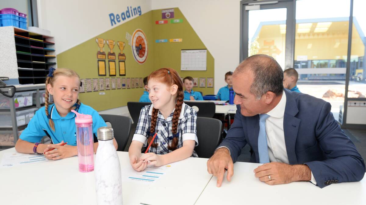 SCHOOL READY: Izabella and Nyah get to work with Victorian Education Minister James Merlino on the school's first day. Picture: Kate Healy