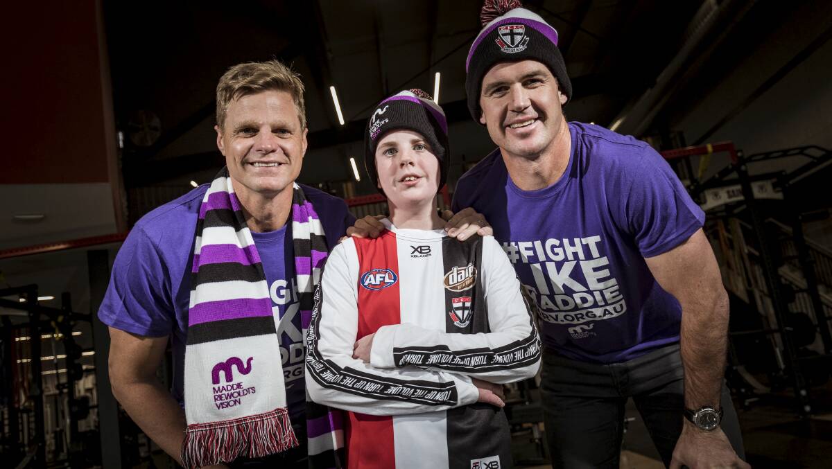 UNITED: Blake Dridan with AFL icons Nick Riewoldt and Jonathan Brown, who will lead Maddie's challenge. Blake features on the AFL Record cover with Riewoldt. Picture: AAP