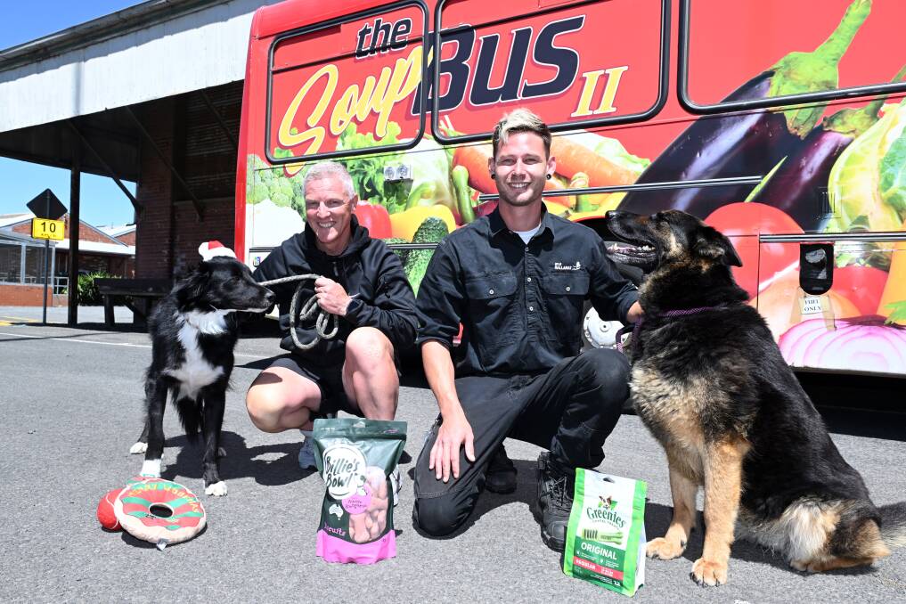 Shelter dogs Franklin (border collie) and Sharni (German Shepherd) put the call out for people to help "Santa Paws" alongside Ballarat Soup Bus founder Craig Schepis and the shelter's Brad Teh. Picture by Kate Healy