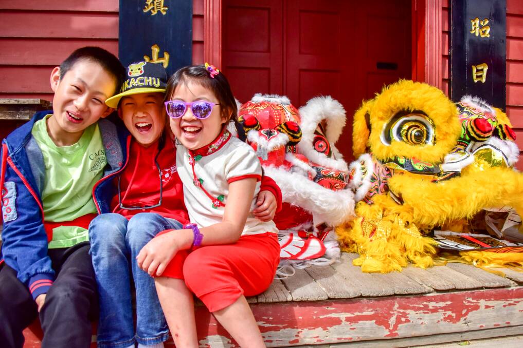 OUTLOOK: Louis, Jayden and Adeline celebrate Chinese New Year in the Chinese village, which is touted for upgrades in Sovereign Hill's new master plan. Picture: Brendan McCarthy
