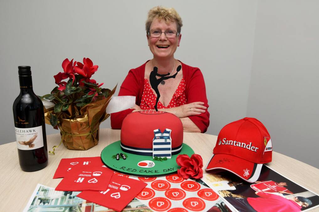 BRIGHT NOTE: Alison Smith with her red cake, red wine, red flowers and red accessories to spark haemophilia awareness. Picture: Lachlan Bence