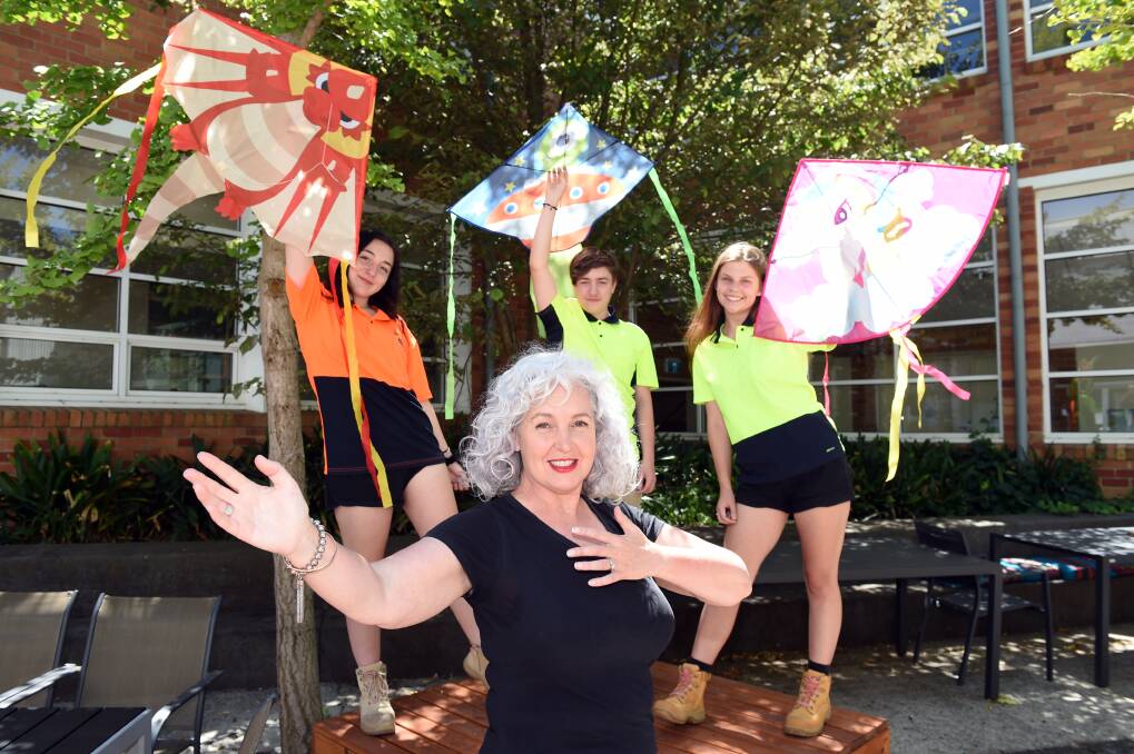FLYING START: BGT's Anita Godfrey gets ready to dance as landscape students Kaitlyn Green, Kobi Maunder and Mashayel Richardson sail kites on sale to boost the dance campaign. Picture: Kate Healy