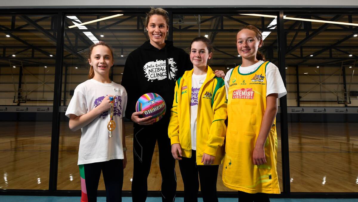 GOLDEN: Retired Australian Diamond Julie Corletto takes junior netballers Lucy Trigg, Lizzy Day and Charlotte Prendergast for a sneak peek at Ballarat's newest netball courts which will open this weekend. Picture: Adam Trafford