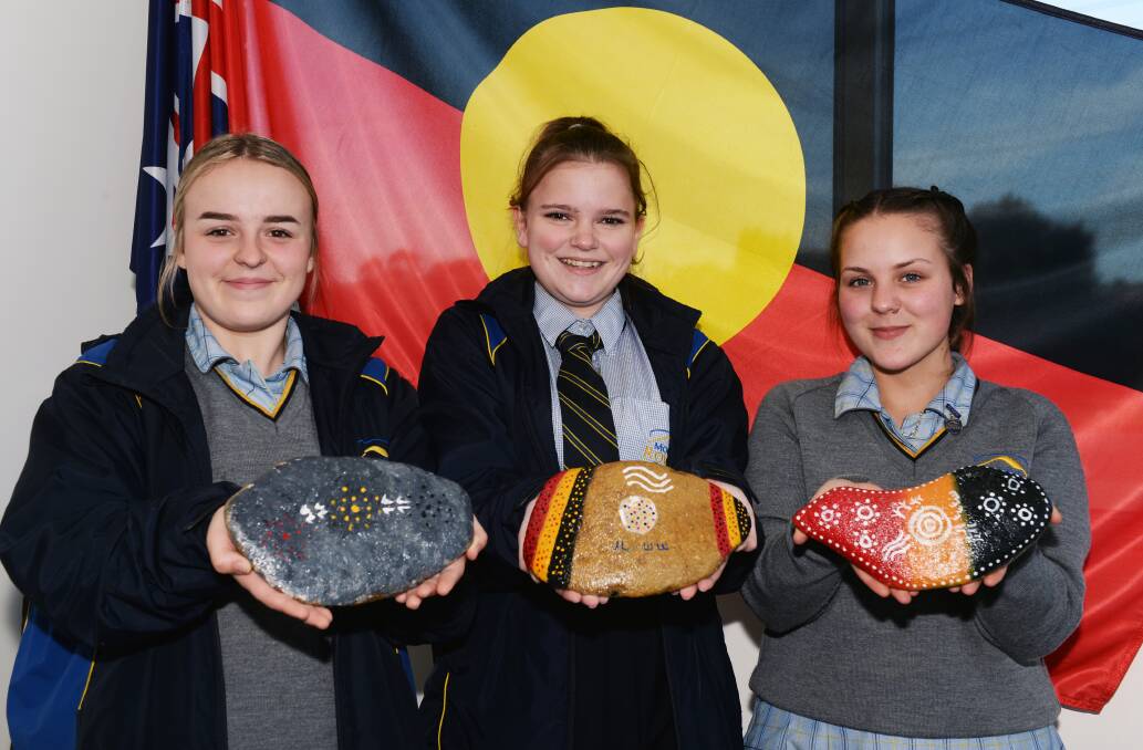 SHARING: Mount Rowan Secondary College Indigenous students Dakota Campbell, Dekoda Kerr and Maggie-Rose Brooks with their stories set on stone to help raise culture awareness at school. Picture: Kate Healy