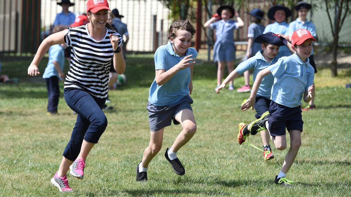 Mount Pleasant Primary School student-teacher relay showdown: Jane Delorenzo, Marcus Borch, grade 6, Johnny Burgess, grade 1, and Ryder Hill, grade 3. Picture: Kate Healy