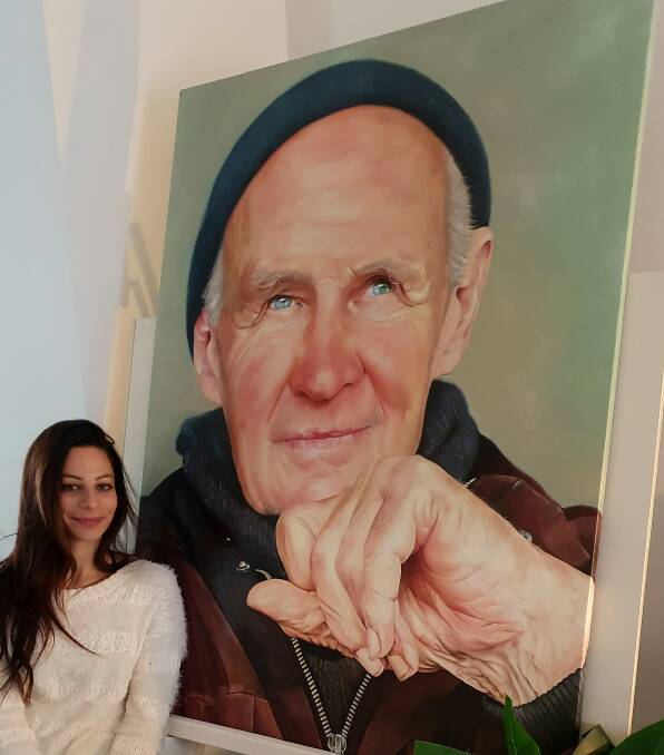 READY: Diggers Rest artist Antoniette Preston with her portrait of Ballarat trainer Paddy Payne. Picture: courtesy of Antoniette Preston