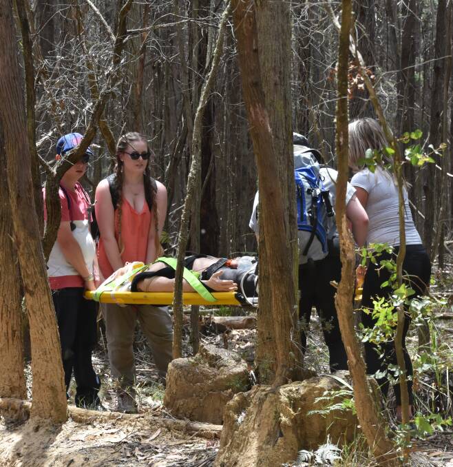 BUSH RESCUE: ACU paramedic students carry their case study in search and rescue training in Wombat State Forest. The bush simulation exercise is unique to ACU.