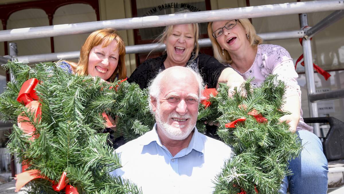 Clunes Neighbourhood House Volunteers Lana De Kort, Viktoria Bach, Liz Bach and David Callinan pose for a photo with Christmas decorations in the main street in Clunes last year. Picture: Dylan Burns