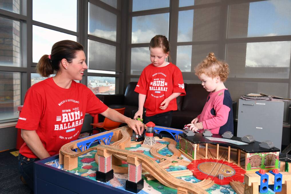 CLOSER LOOK: Run Ballarat ambassador Gorgi Coghlan and daughter Molly-Rose play with patient Isabelle in the temporary children's ward at Ballarat Health Services Base Hospital. Picture: Kate Healy
