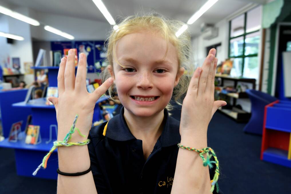 SMILES: Canadian Lead pupil Emily has been busy making and sharing friendship bracelets to show people she cares. Picture: Lachlan Bence