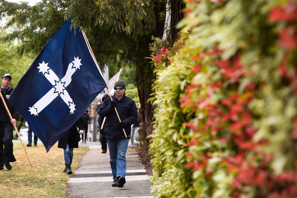 LEGACY: Stephen Whitehead carries a Eureka Flag in the democracy walk. Pictures: Adam Trafford