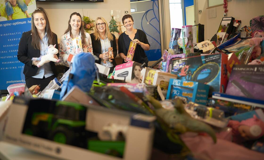 In-kind: PostureWorks' Zoe Keith, chiropractor Eleanor Cafra and Melinda Yarwood with Centacare manager Jacinta Cook look over donations. Picture: Luka Kauzlaric