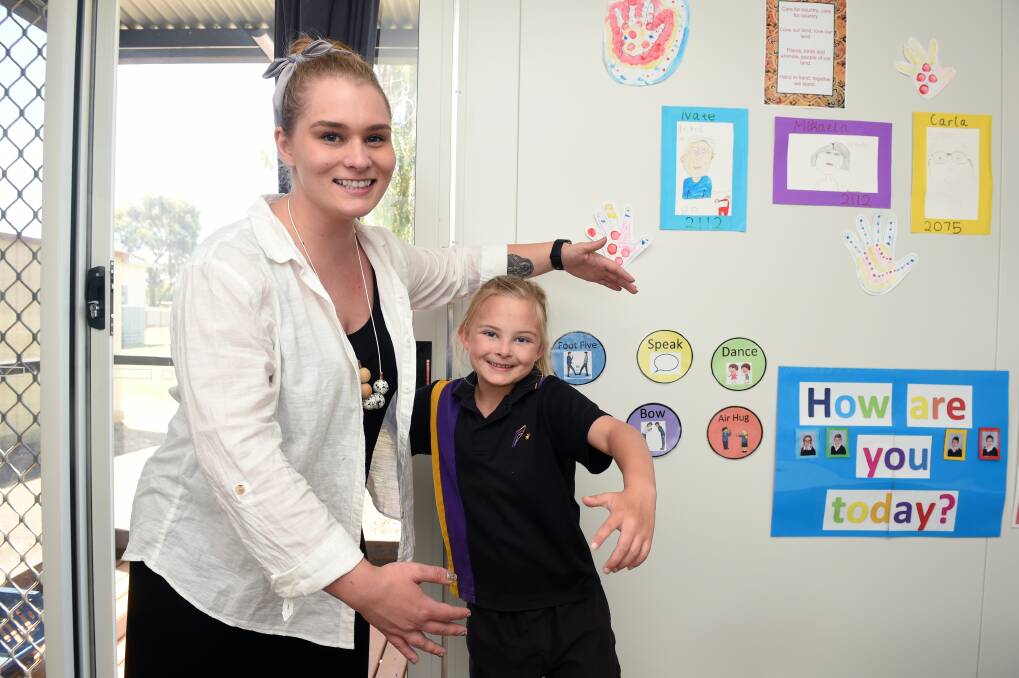 WELCOME: Mikaela gets to choose how Phoenix College social worker Mary Bourke greets her in the Nurture Room, like a COVID-safe air hug. Picture: Kate Healy