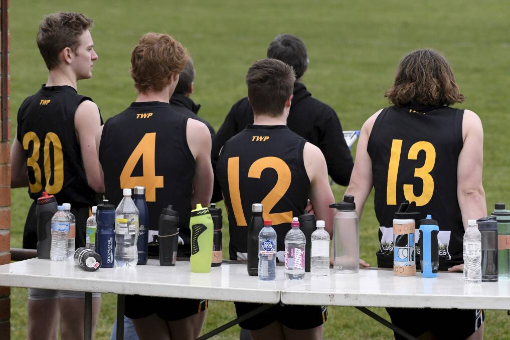ADAPT: COVID-19 forced a change-up in how players must hydrate, as pictured with Springbank under-18s, to help stay safe on the field this past year. Picture: Lachlan Bence