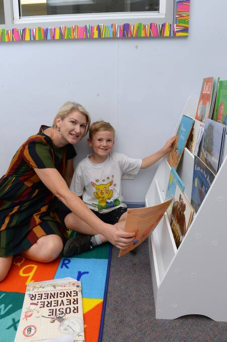 Graduate teacher Julia McGregor prepares a reading corner with son Angus for her first class at Buninyong Primary School. Picture by Kate Healy