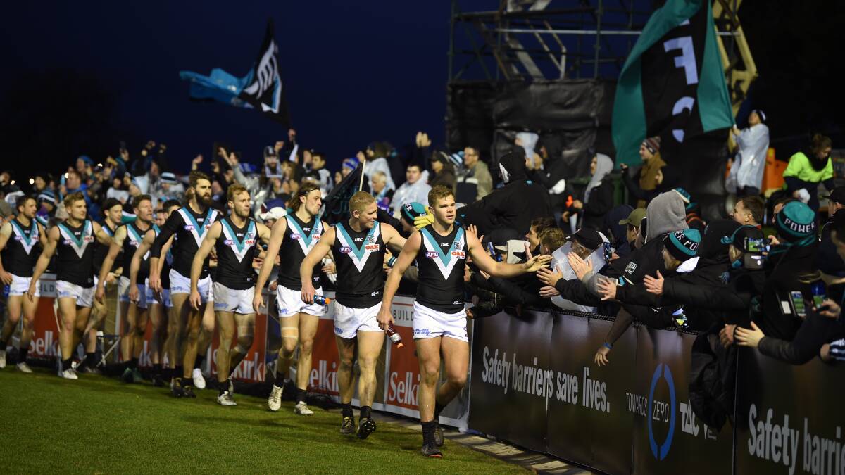LOW POWER: Port Adelaide celebrates its win in what fans and coaches have deemed hard to see at Mars Stadium on Sunday evening. Picture: Kate Healy