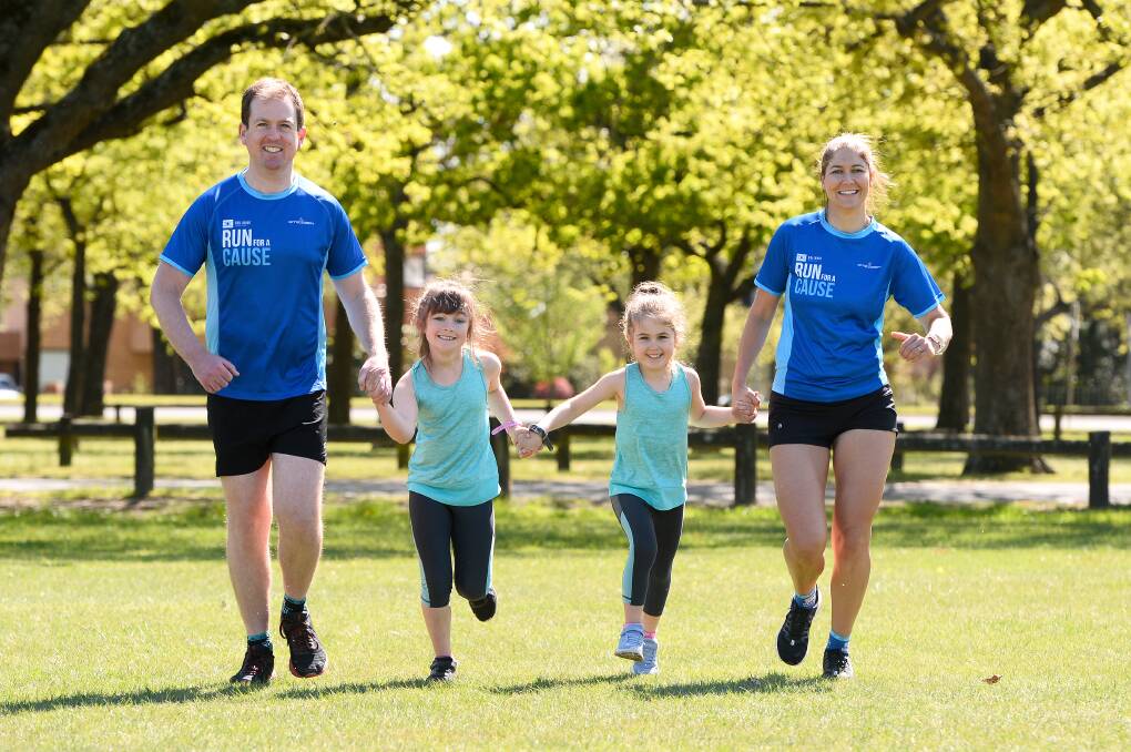 TOGETHER: Leigh and Chris Hutchinson with Izzy, age six and Claire, five, ready to virtually Run for a Cause next month. Picture: Adam Trafford
