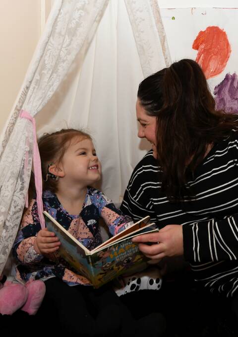 SHARE: Three-year-old Mackenzie with mum Tamara Donnelly enjoy a fun new tale via the Imagination Library. Picture: Lachlan Bence