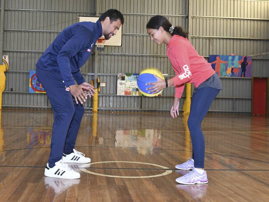 CASUAL HOOPS: Ballarat Miner Joshua Fox goes toe-to-toe with 12-year-old Hope for Drop-In Basketball at the YMCA. Picture: Lachlan Bence