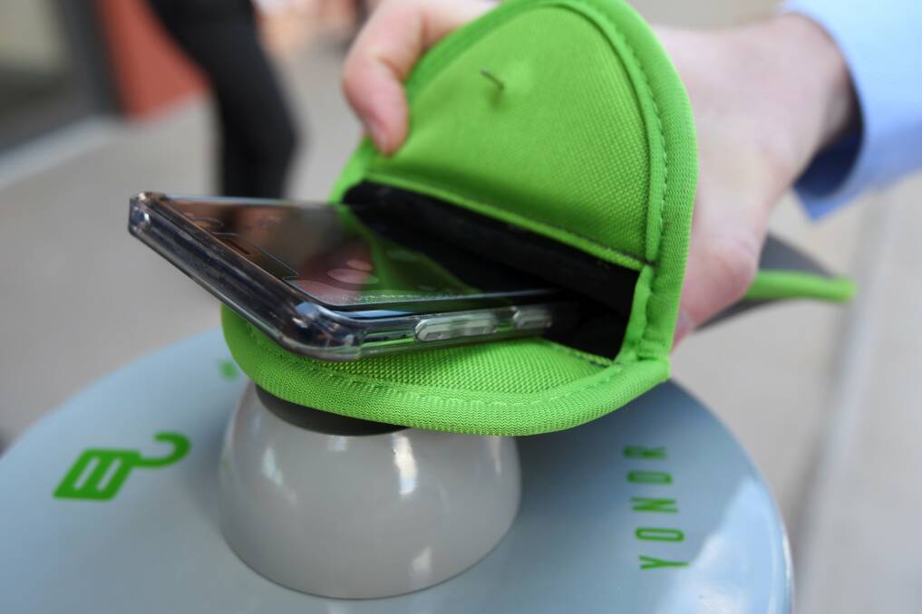 CASE IN POINT: Students can open the Yondr pouch after the final bell on an unlocking station. Picture: Lachlan Bence