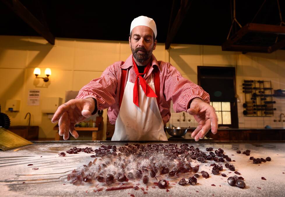 SMASHING TIME: Sovereign Hill confectioner Ben Bignell has batches of raspberry drops at the ready from his first day back in Brown's Confectionery shop. Picture: Adam Trafford