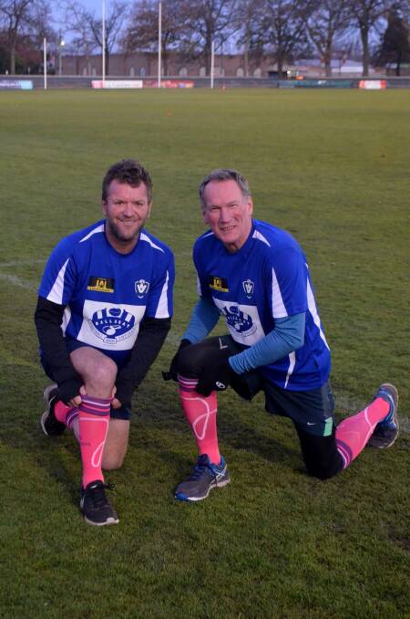 BRIGHT NOTE: Ballarat Football Umpires Association's Brendan Johnston with board director Richard Carroll, pulling up their pink socks to support the McGrath Foundation.