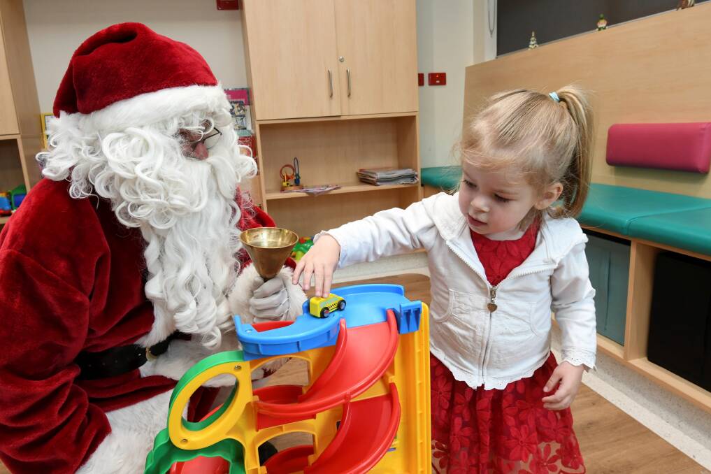 SPECIAL GUEST: Santa Dave checks in on five0year-old Imogen Fawcett on his rounds in Ballarat Health Services Base Hospital children's ward. Picture: Lachlan Bence