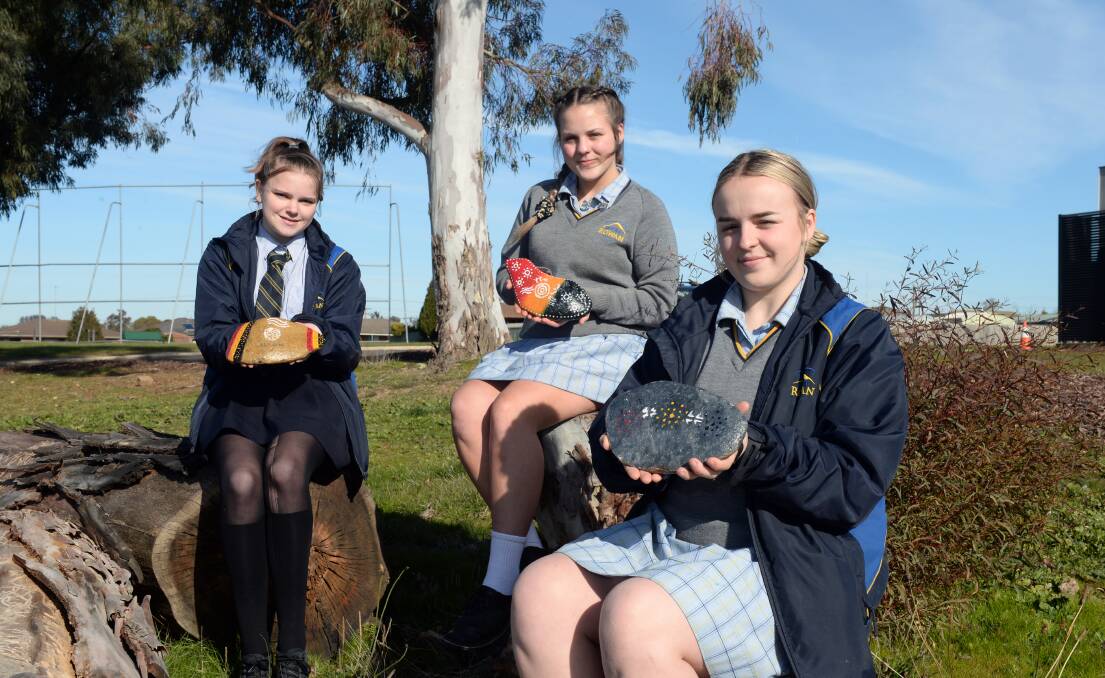 SHARING: Mount Rowan Secondary College Indigenous students Dekoda Kerr, Maggie-Rose Smith and Dakota Campbell with their stories set on stone to help raise culture awareness at school. Picture: Kate Healy