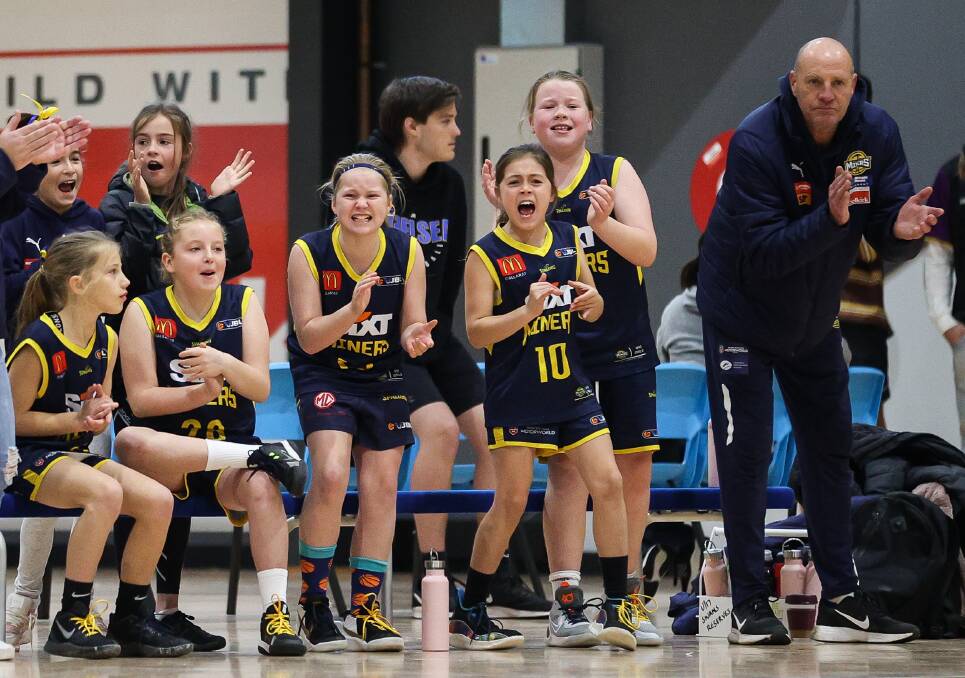 Ballarat Miners under-12 girls with coach and former Miners' captain Glenn White in full voice from the bench in the Basketball Ballarat annual junior tournament last year. 