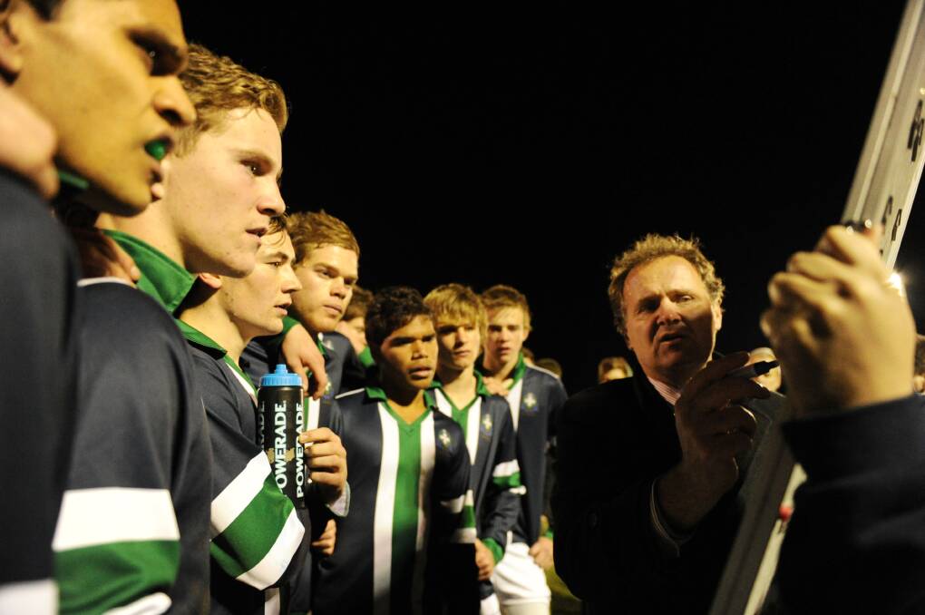 Biggest football game of the year in 2011 - Howard Clark instructs his players in the Ballarat Associated Schools football first XVIII grand final against Ballarat Clarendon College under lights. 