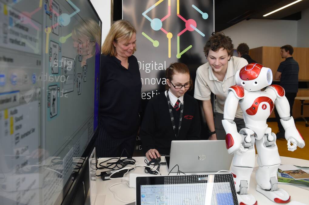 TECH SUPPORT: Visit Ballarat industry and development manager Serena Eldridge works with Mount Clear College students on a robot project at Ballarat Tech School last year. Picture: Kate Healy
