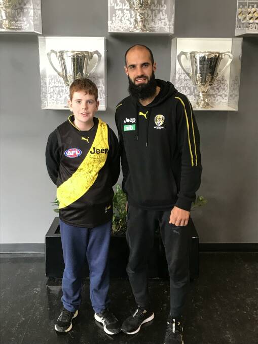 CHALLENGE: Tiger Bachar Houli shows Blake Dridan the club trophy cabinet, which the Tigers hope to add to with AFL Grand Final on Saturday.