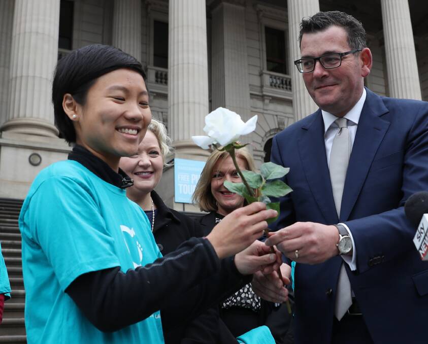 SEND-OFF: Belinda Teh receives a white rose, in tribute to her mum, from Victorian Premier Daniel Andrews as she sets out to walk to Perth in a bid to raise awareness of assisted dying laws, unavailable in her home state. Picture: AAP