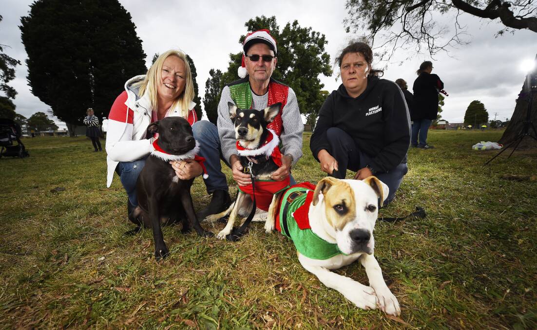 HAPPY HOWLIDAYS: Anne Garreffa with Bella, Frank Hinde with Kimba and Rebecca Munari with Rocky at the Wendouree Dog Squad Christmas party. Picture: Luka Kauzlaric