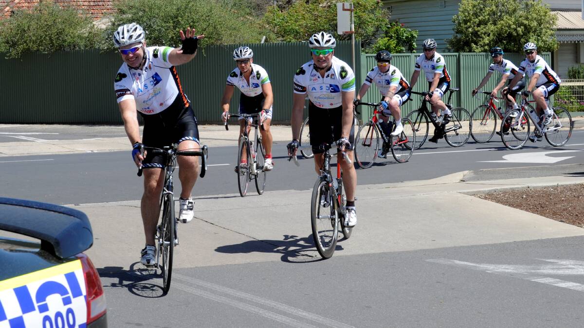 COMMUNITY FOCUS: Passionate about helping the region, Danny Frawley and fellow AFL footballer Michael Roberts riding with Cops and Kids Camp into Maryborough in 2012.